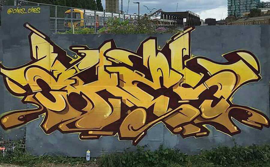 Yellow graffiti Mural by Ches